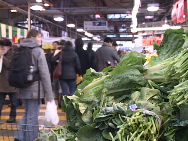 vegetables and people in an indoor market