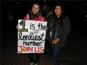 two girls hold up a sign