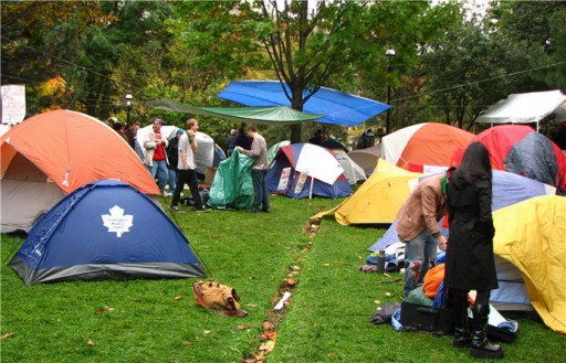 people and tents in a city park
